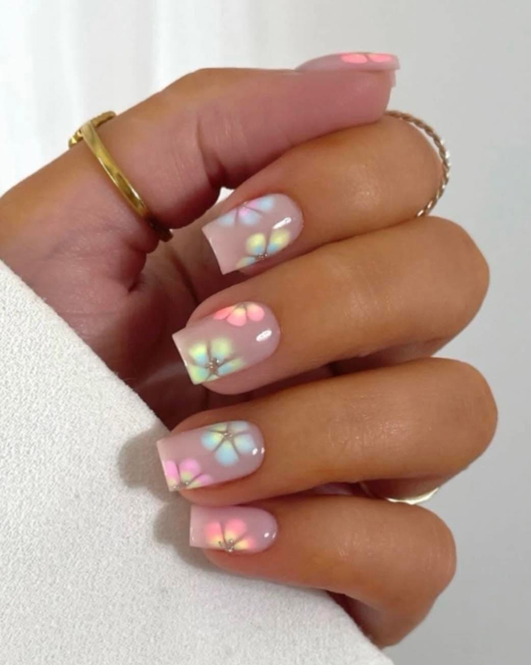 Short nude nails with pastel hand-painted flowers